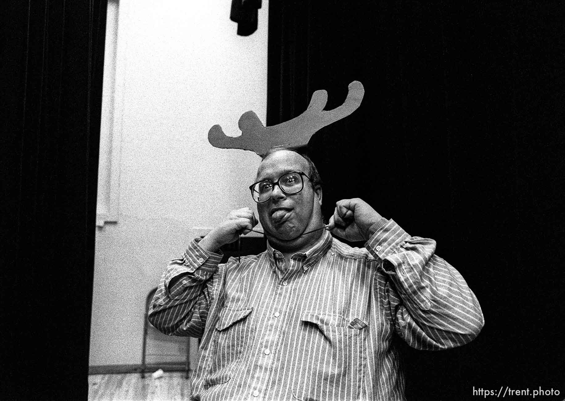 Man putting on antlers at Walnut Creek 2nd ward Christmas Party.