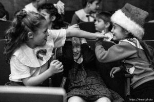 Girl in the middle of a play-fight ducking at Walnut Creek 2nd ward Christmas Party.