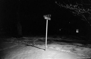 Main St sign and snow at night