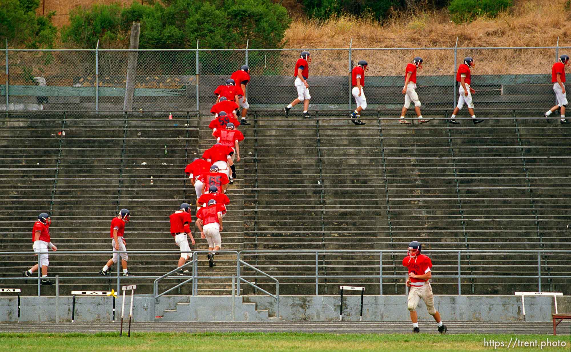 Campolindo football players walk the bleachers at practice