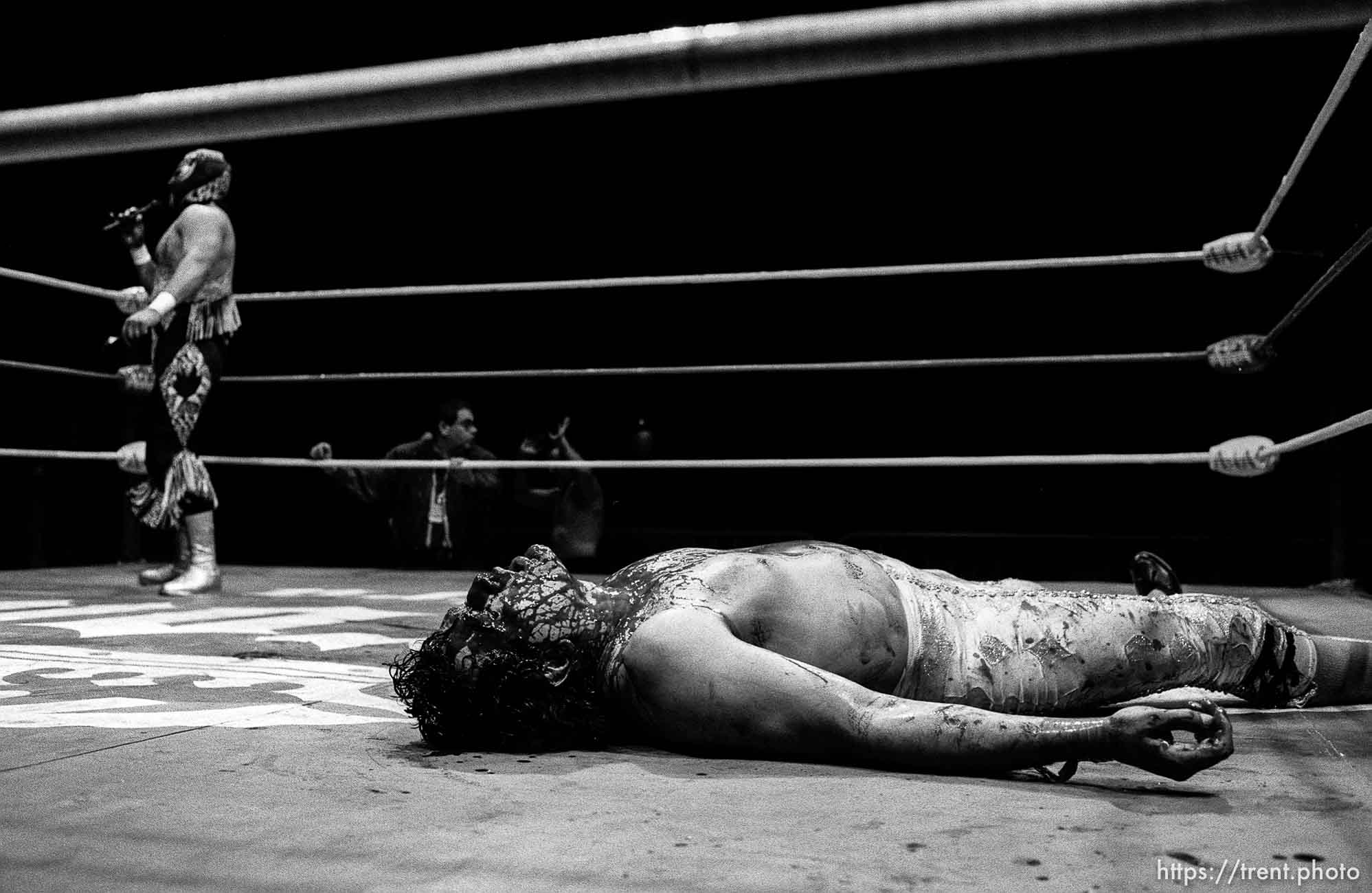 Wrestling action at Luche Libre pro-wrestling. guy covered in blood