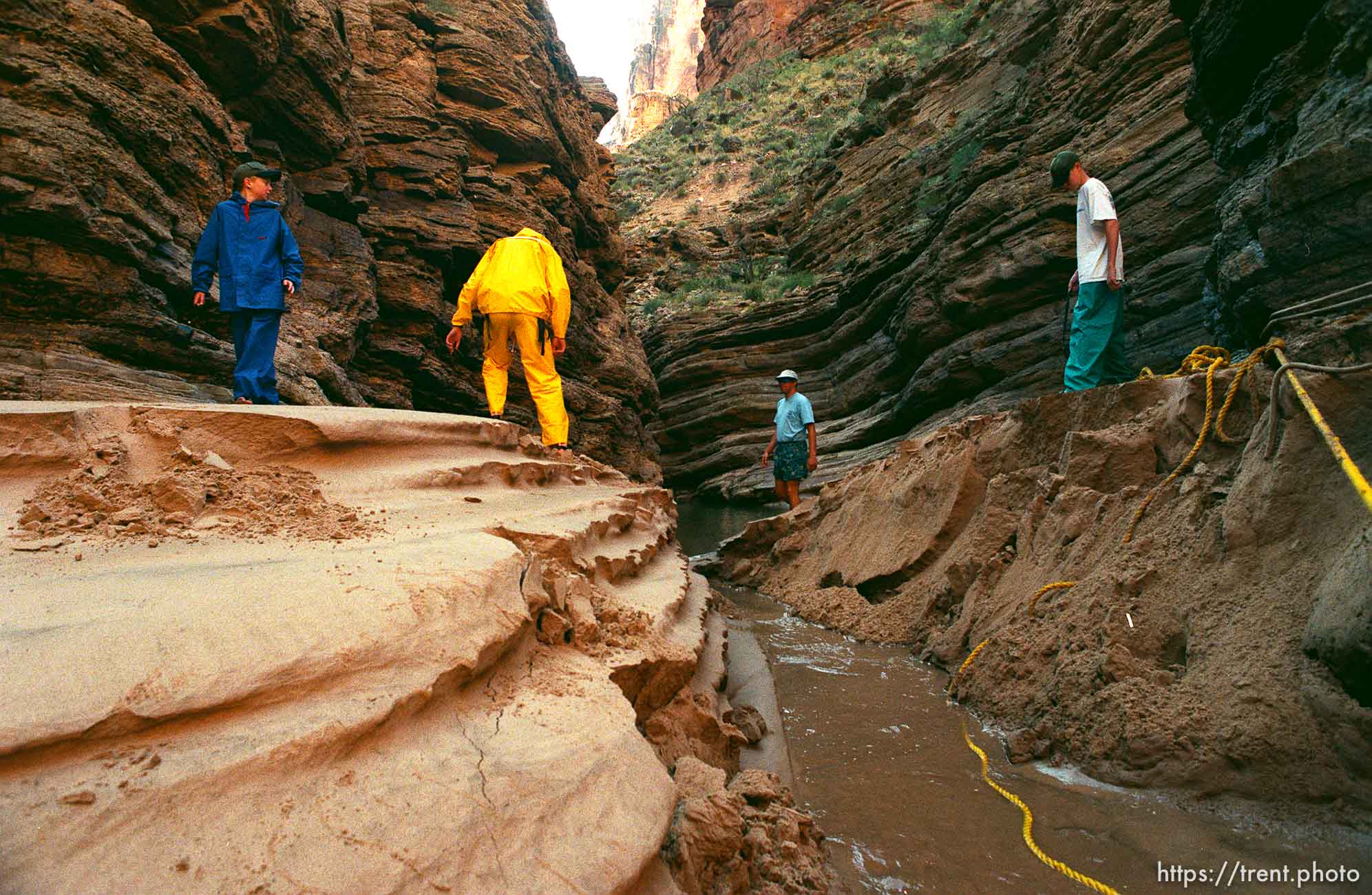 People walking on newly created sand beaches. Grand Canyon flood trip.