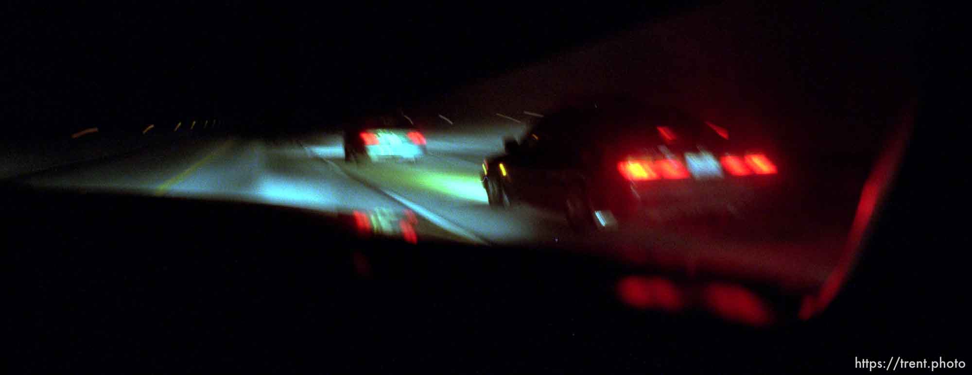 A carload of Oriental Posse members (right) races down the Bangerter Highway.