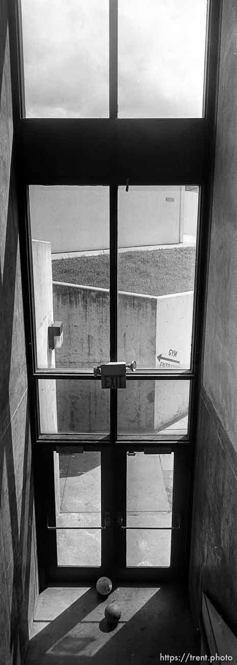 Volleyballs and window in gym at California High School.