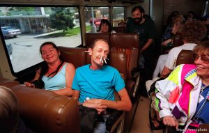 Guy on fun bus with cigarettes in his face.