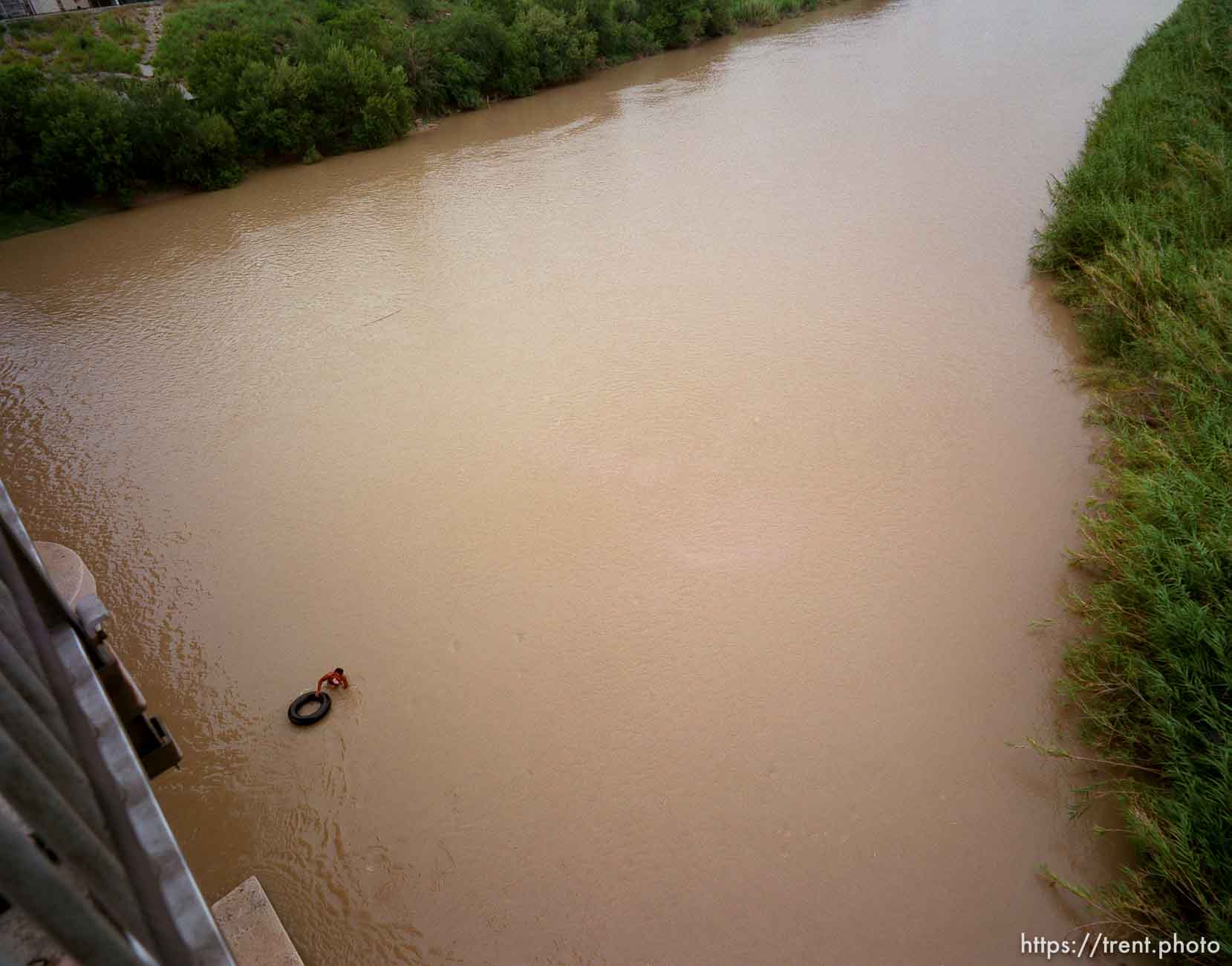 Guy with inner tube in the Rio Grande.