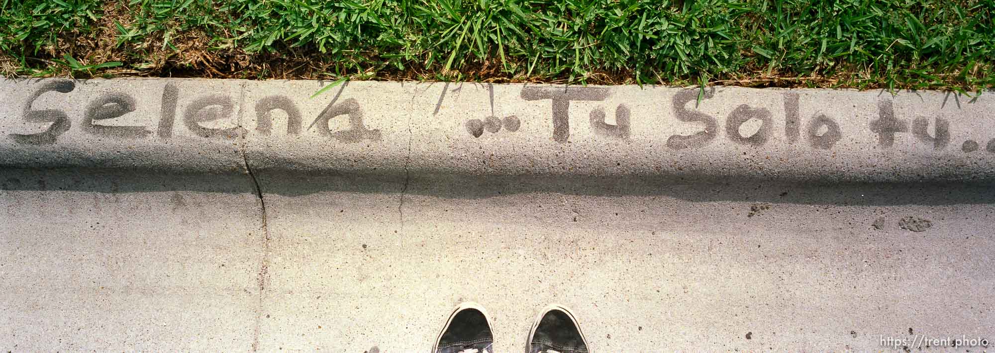 at Selena's house. graffiti on sidewalk