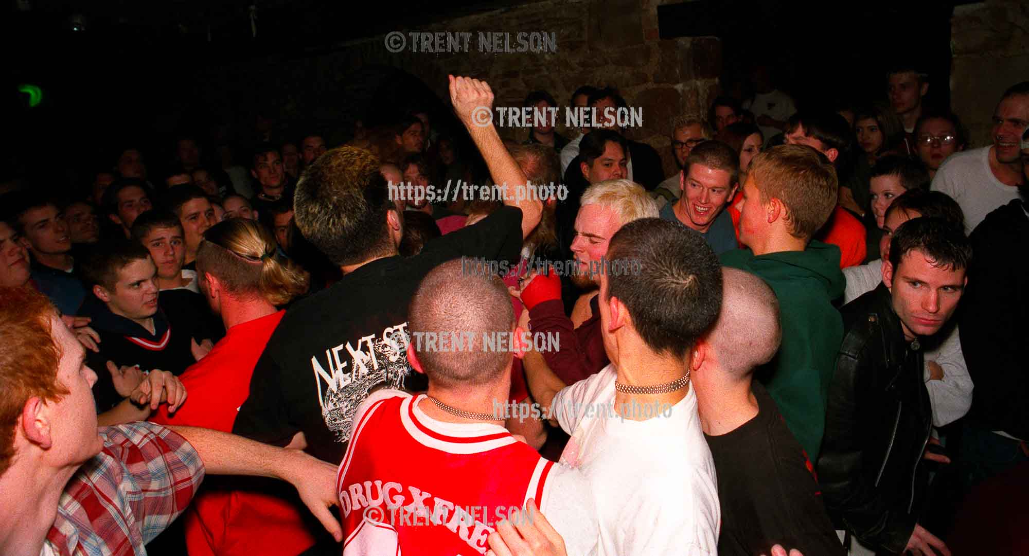 Straightedge kids beat on a longhaired Godflesh fan as he is thrown out of the club. Security figured it would be easier to remove one guy, rather than several violent kids.