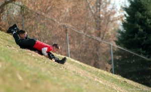 Brothers Ricky and James (red shirt) Shoff try a unique style sliding down an incline at Highland High School.