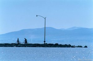 Couple with bikes on pier at Utah Lake.