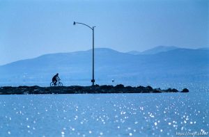 Biker on pier at Utah Lake.