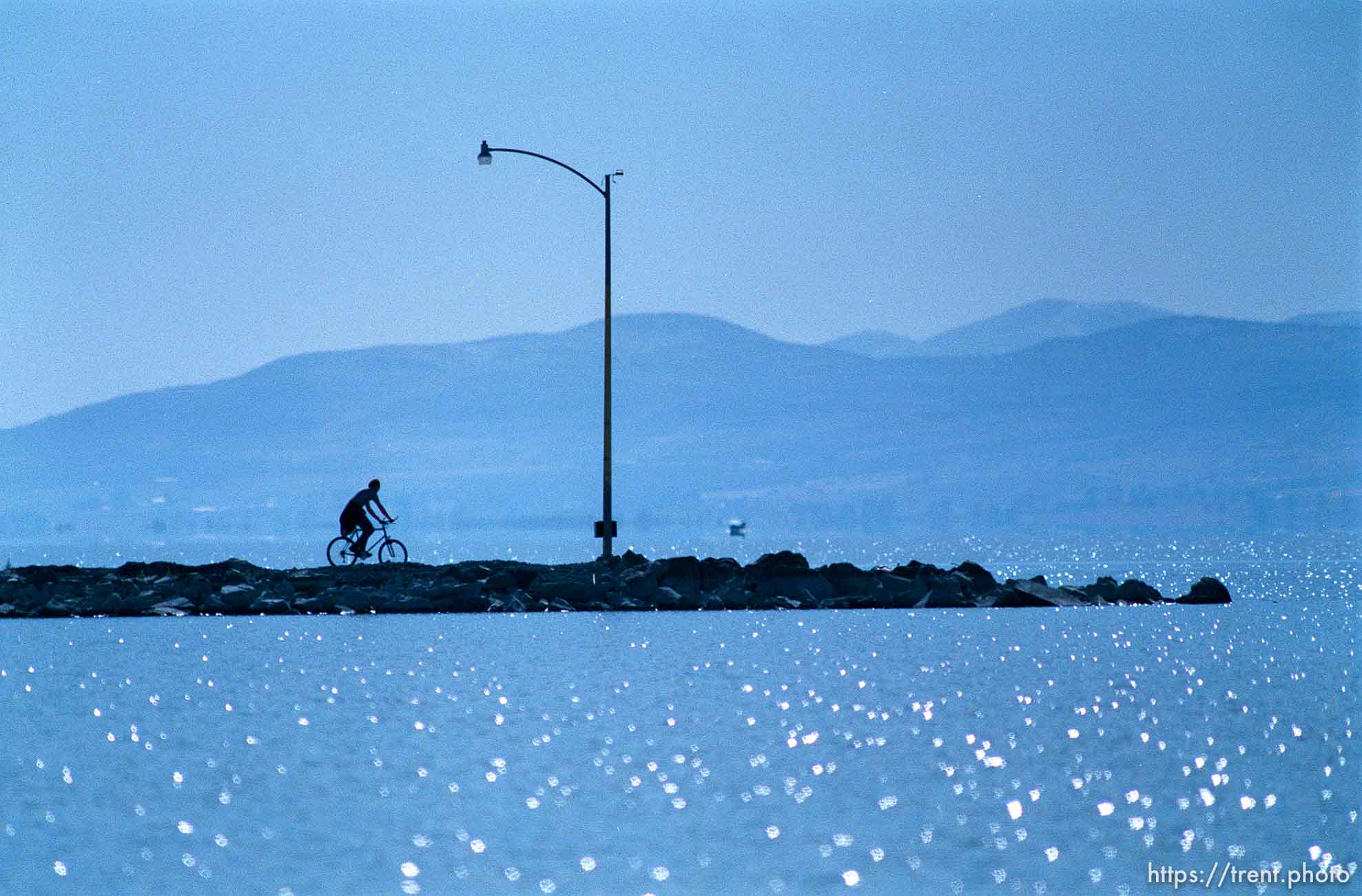 Biker on pier at Utah Lake.