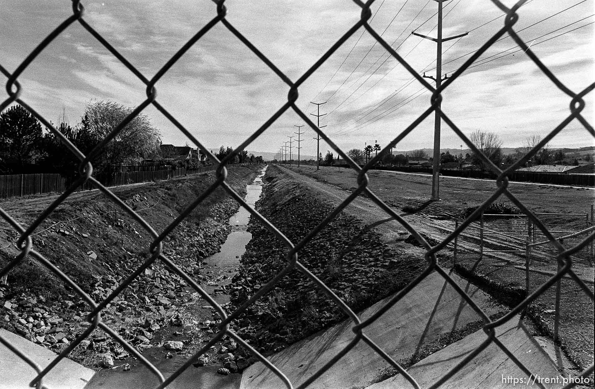 San Ramon Creek, through chain-link fence