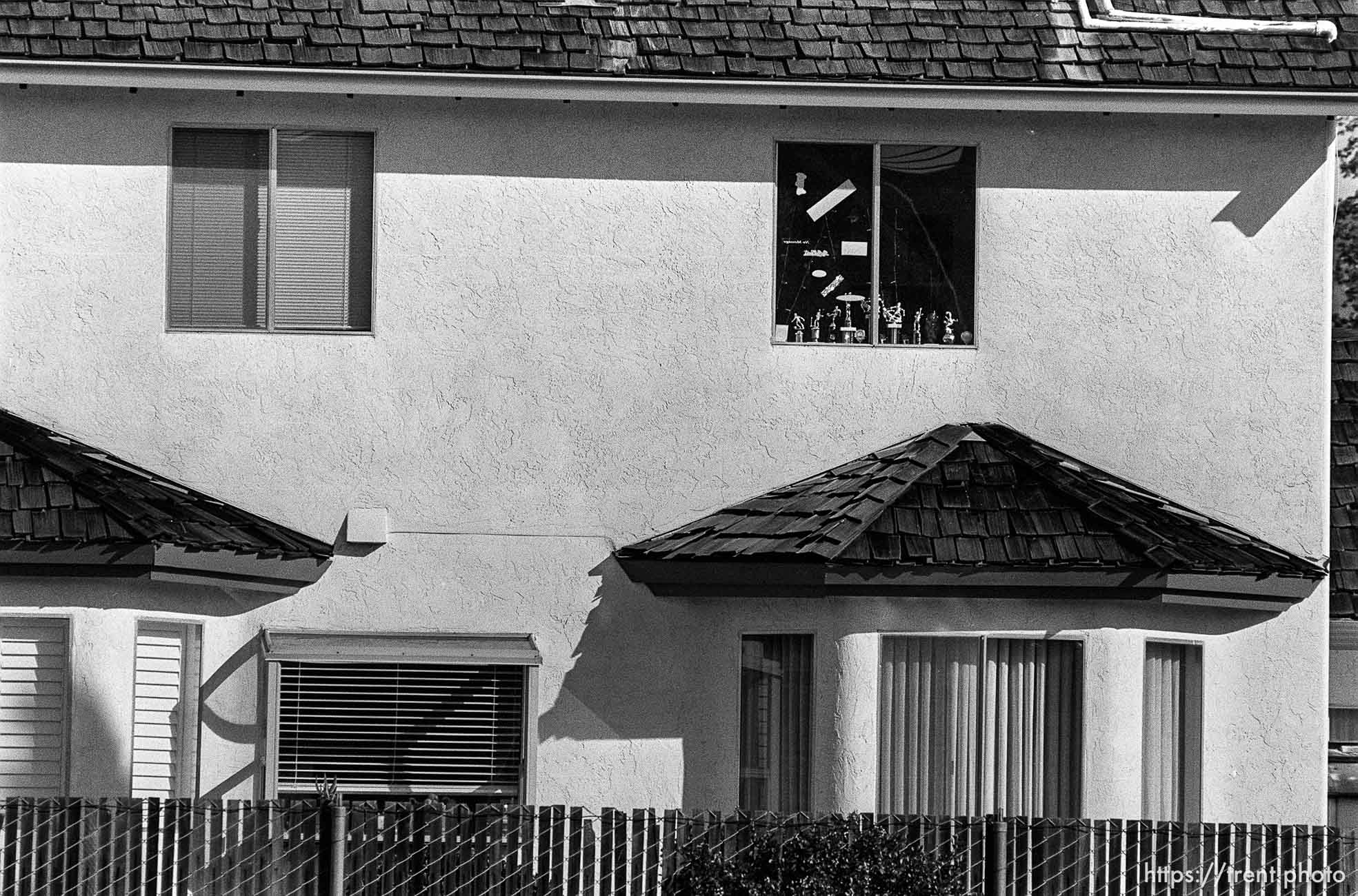 Trophies in window of home.