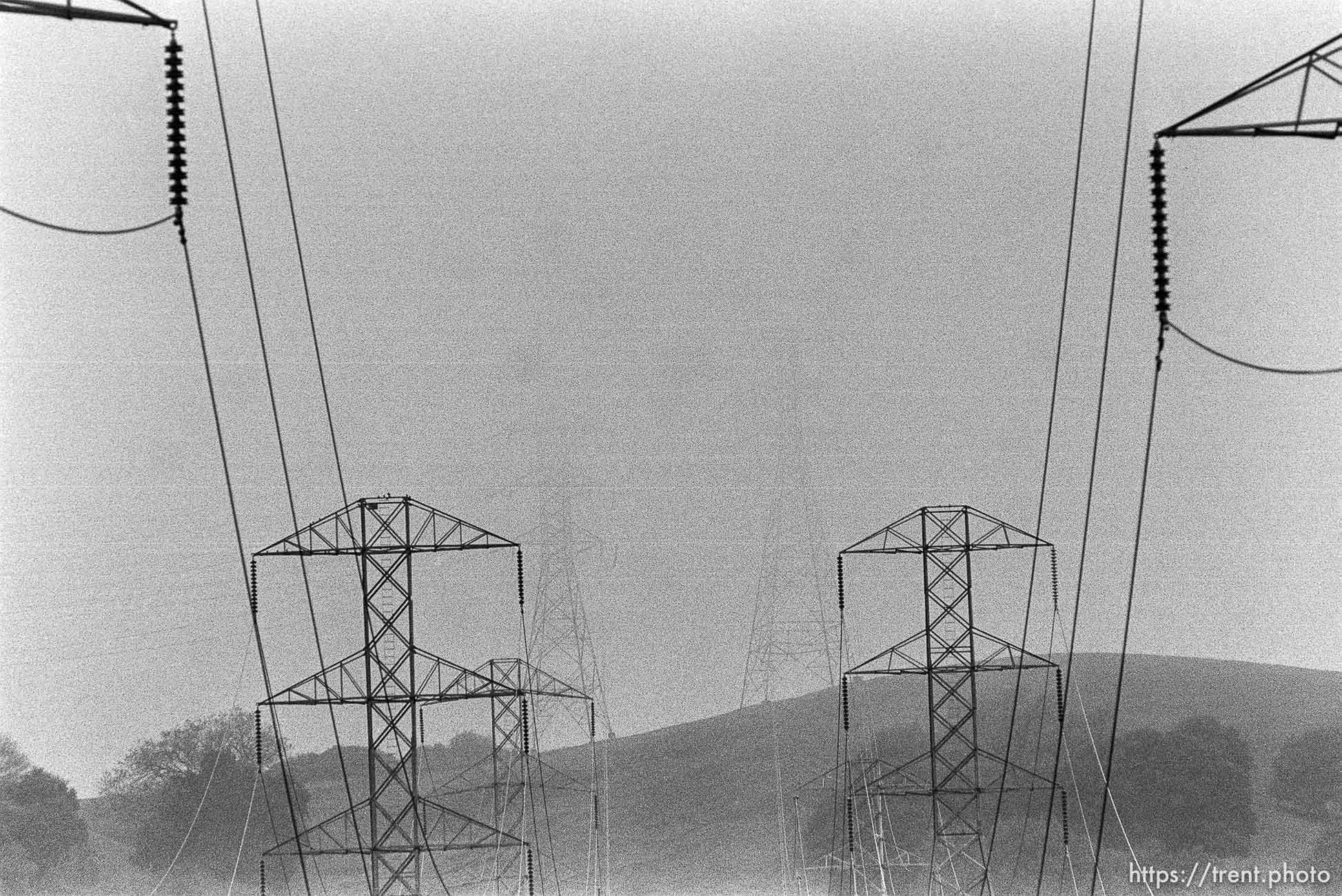 Powerlines and foggy hills