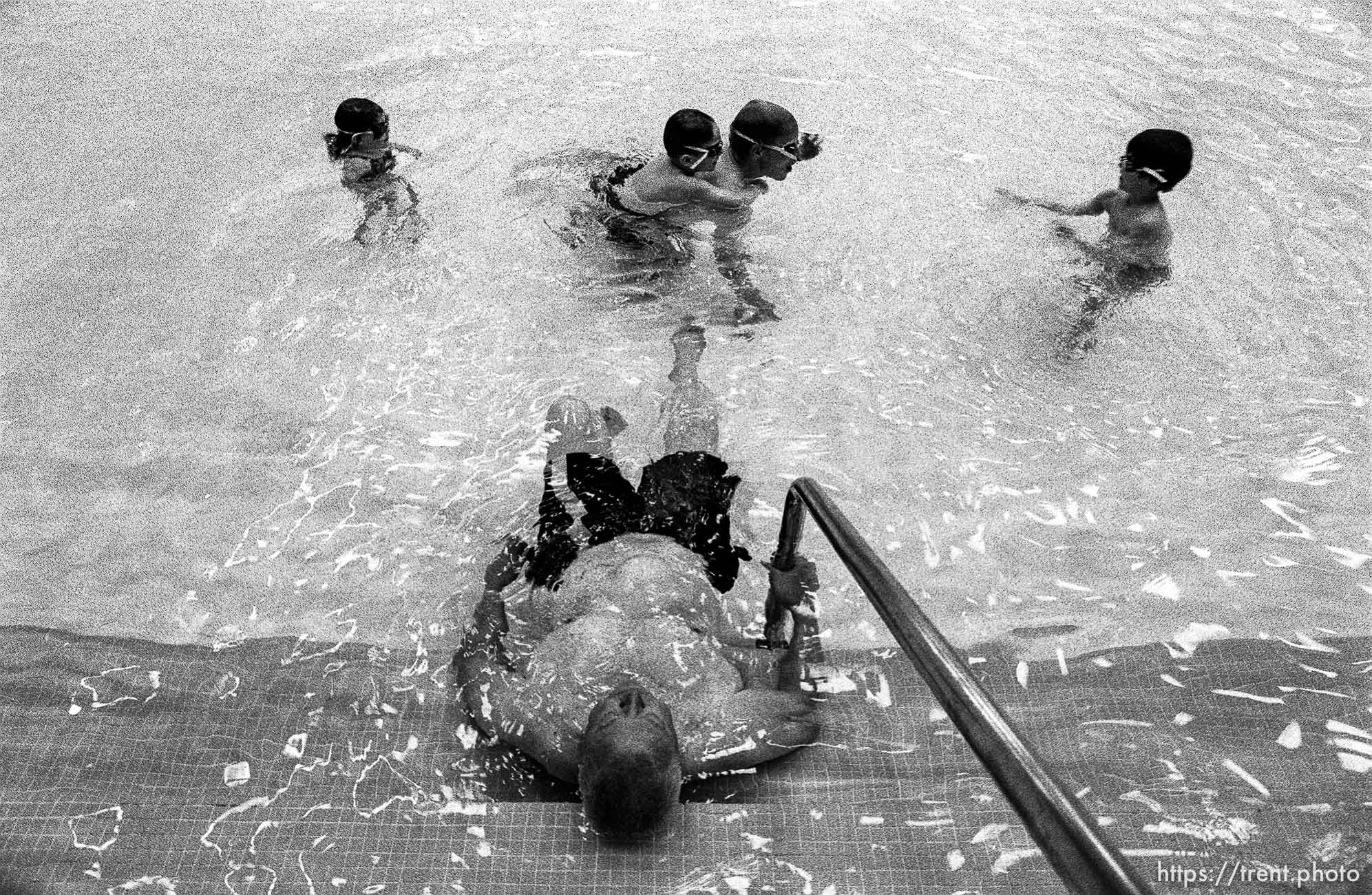 A swimming lesson group and an old man at the Deseret Gym.