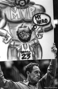 Dr. Richard Anderson holds a sign at Jazz vs. Minnesota Timberwolves.