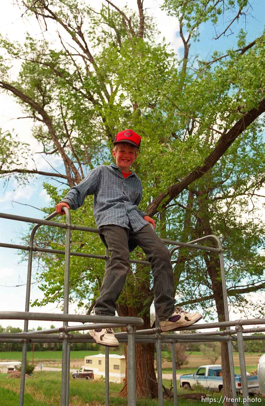 Kevin Sherman, 8, on the bars at a school playground.