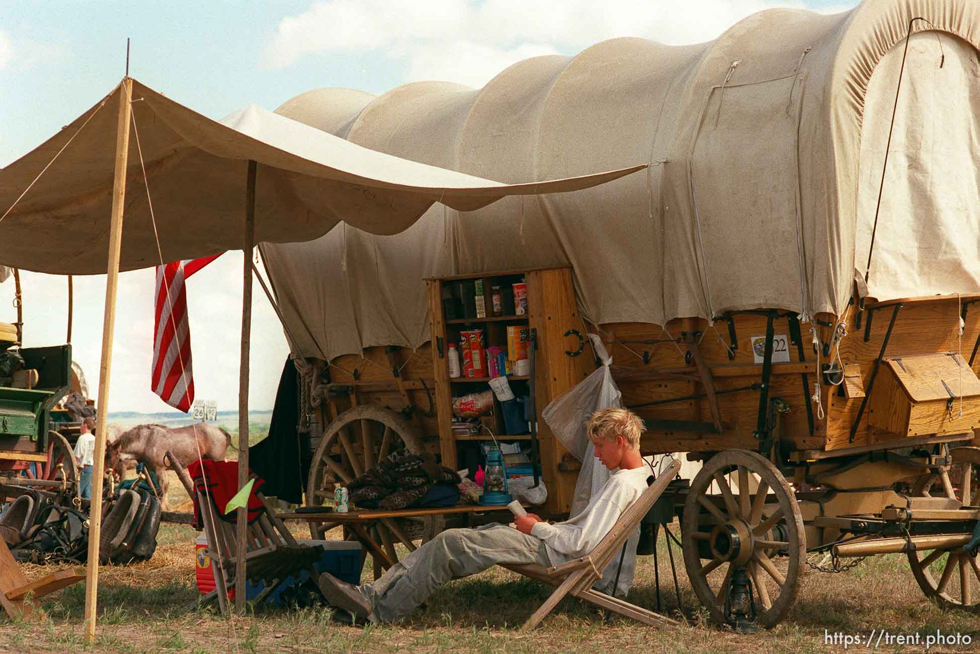 Brenton Whitaker reading in camp on the Mormon Trail Wagon Train.