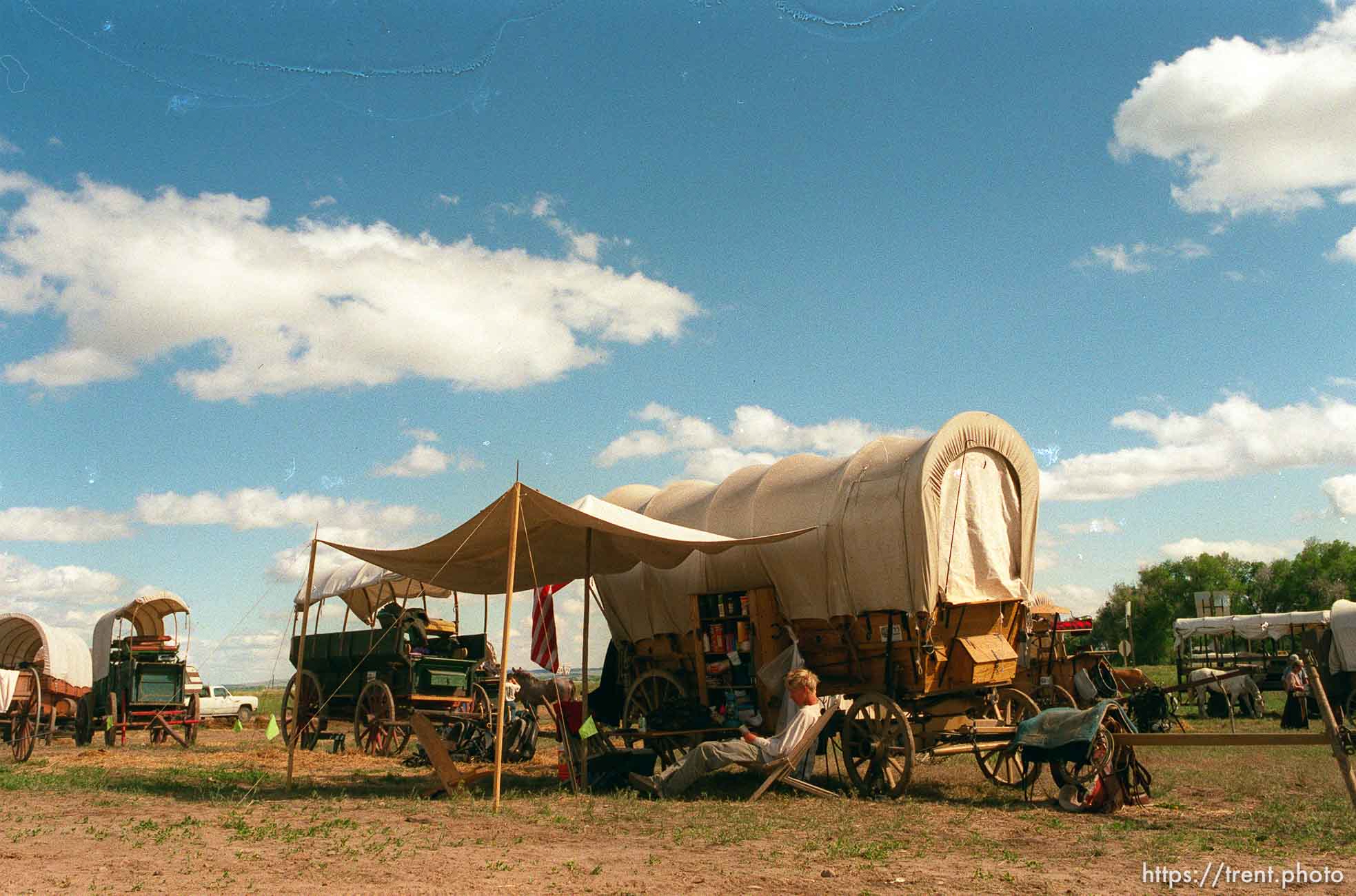 Brenton Whitaker reading in camp on the Mormon Trail Wagon Train.