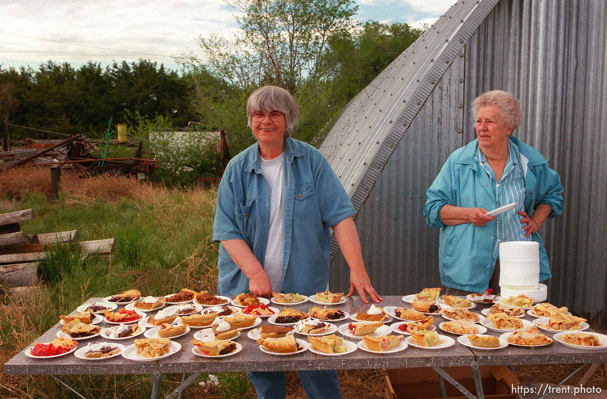 Donna Nelson and Lena Middleton selling pie for a dollar in camp on the Mormon Trail Wagon Train. The money was a fundraiser for Lena's daughter Susan Siffring, who has lukemia and just underwent a bone marrow transplant.