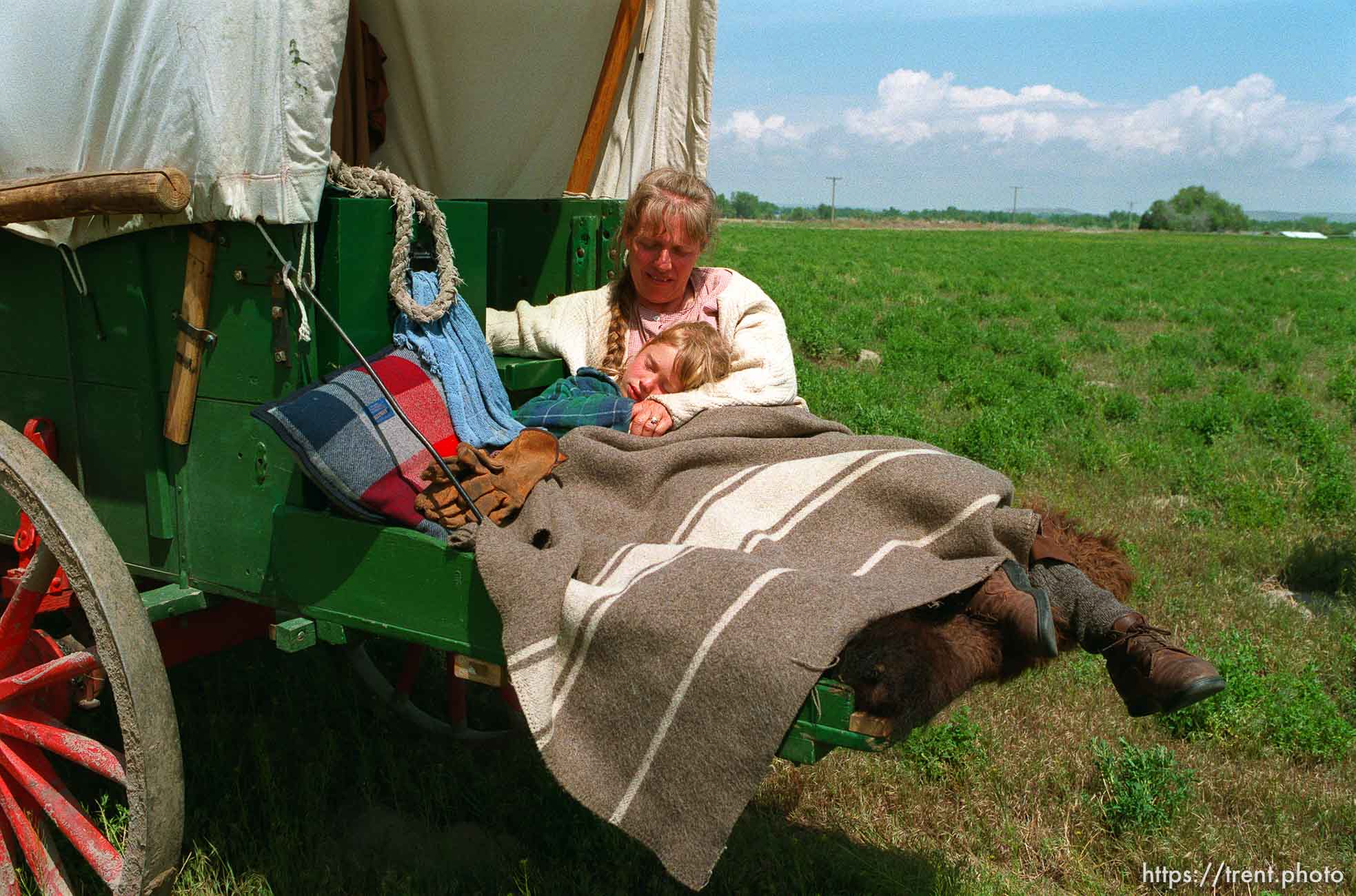 Sarah Dicken, with a 102 degree fever, in her mother Shauna's arms as the Mormon Trail Wagon Train stops for lunch.