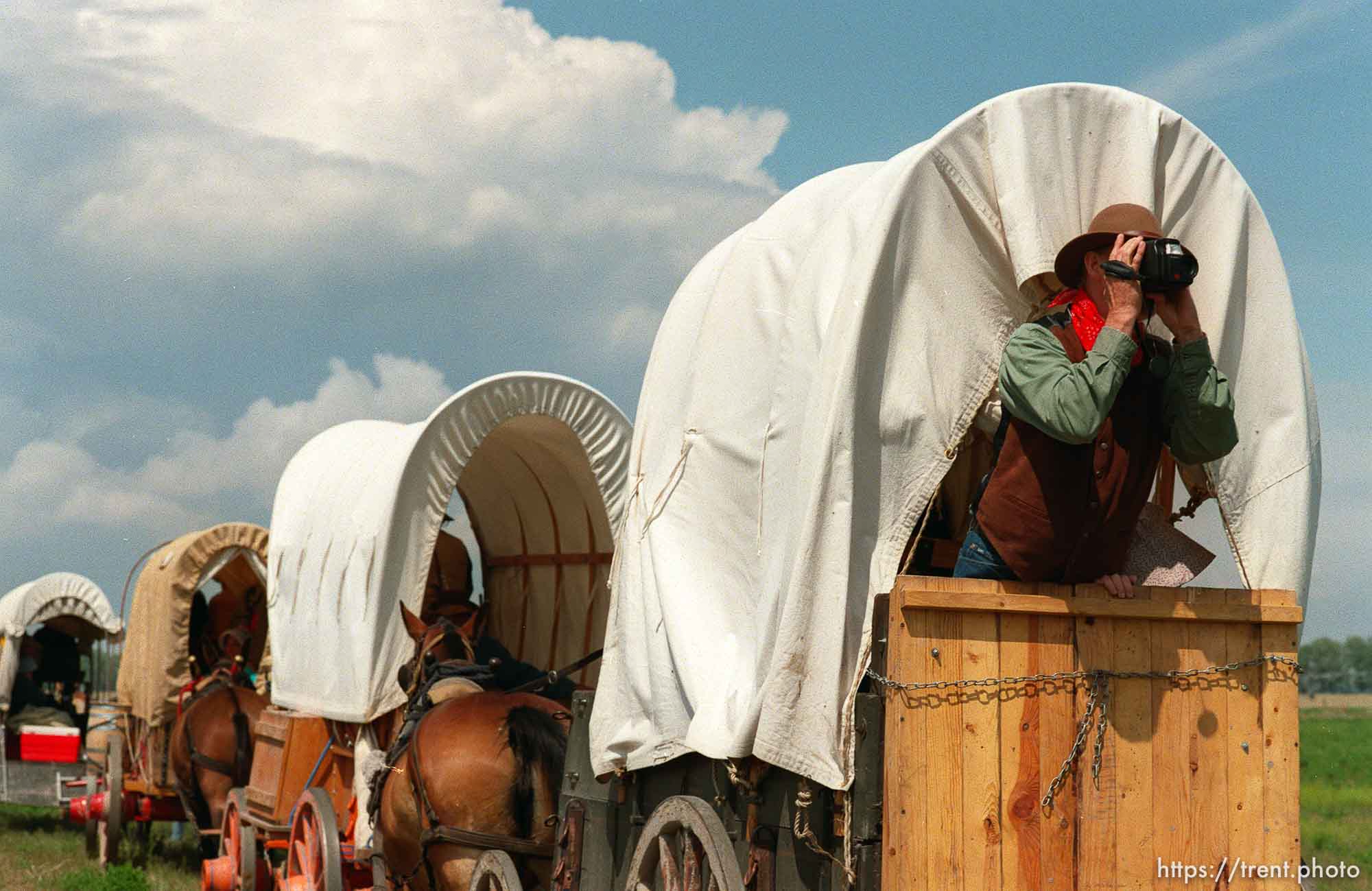 Lee Johnson of Spanish Fork, UT videotapes wagons on the Mormon Trail Wagon Train.