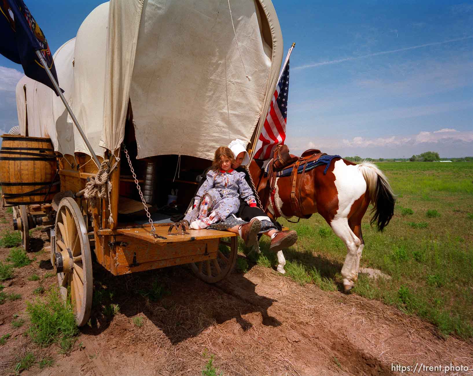 The Whitaker wagon (little girl is Aleah, other person is her mother, Mrs. Whitaker) along the Mormon Trail.