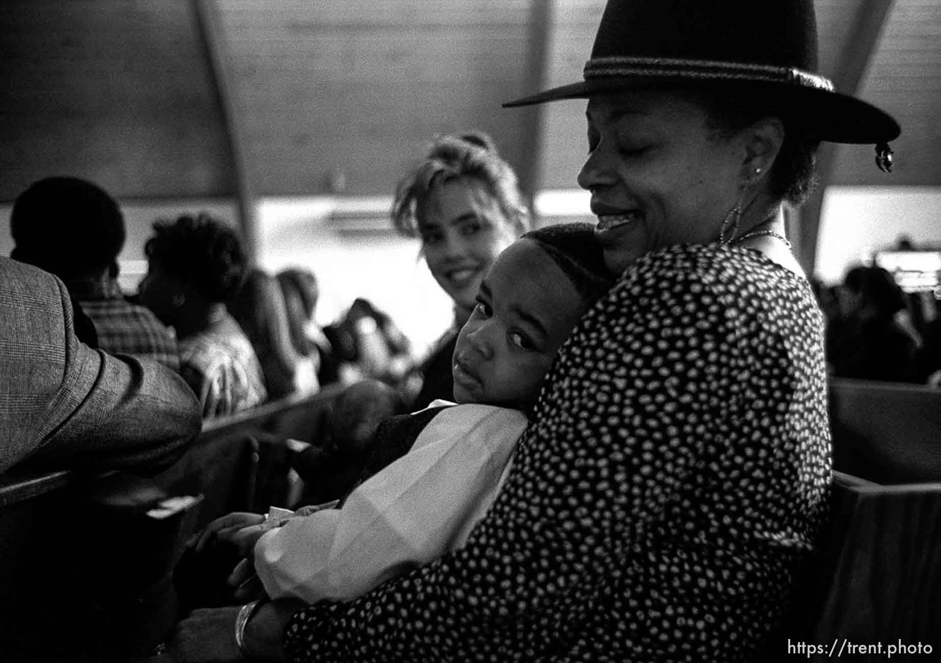 Trevon Bryant sits on his grandmother Margaret Webb's lap during Sunday services at the Calvary Baptist Church.