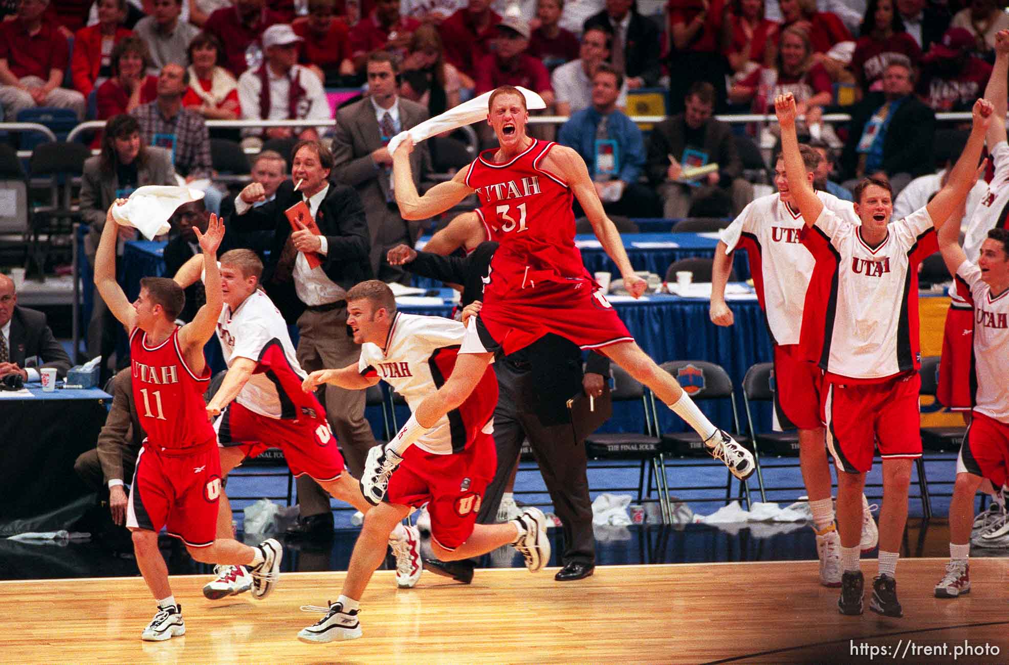 Utah players celebrate their victory over #1 seed North Carolina in the Final Four. Britton Johnsen is #31.