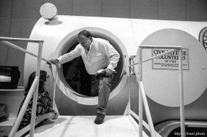 Man climbs out of bomb shelter at the Emergency Preparedness Expo at the Salt Palace Convention Center.