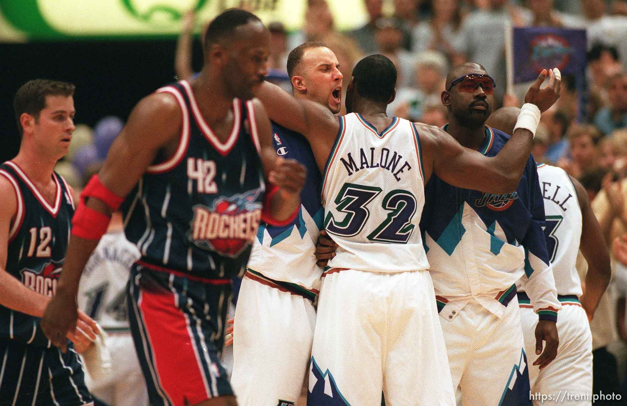 Utah's Greg Foster and Karl Malone embrace as Rockets' Matt Maloney (12) and Kevin Willis (42) walk off court near the end of Utah Jazz vs. Houston Rockets, game 5 of the 1st round, NBA Playoffs. Jazz won.