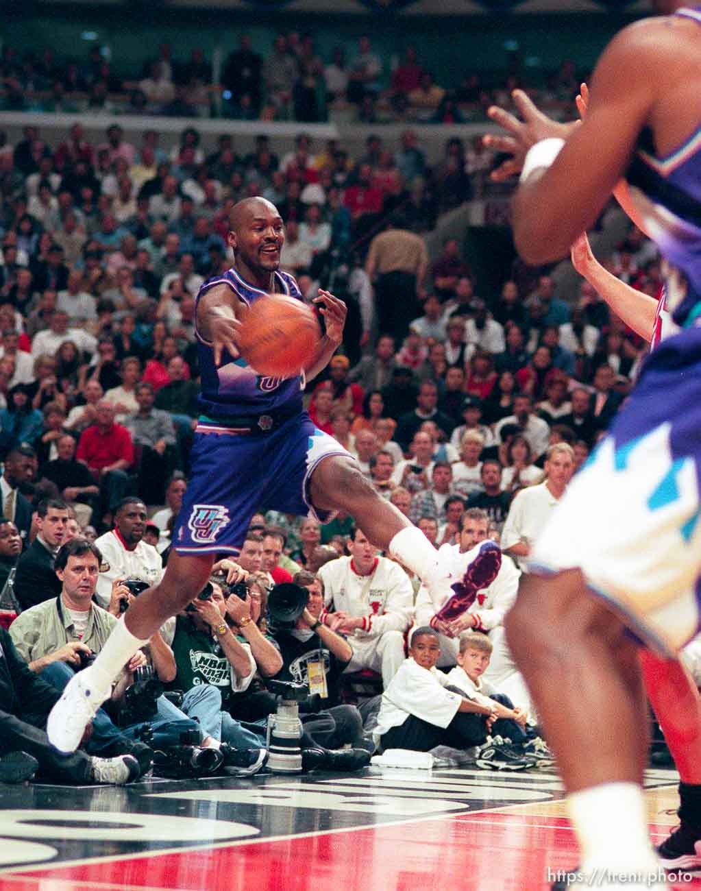 Bryon Russell throws a ball off a Bulls player as he flies out of bounds at Jazz vs. Bulls, game 5 of the NBA Finals. Jazz won