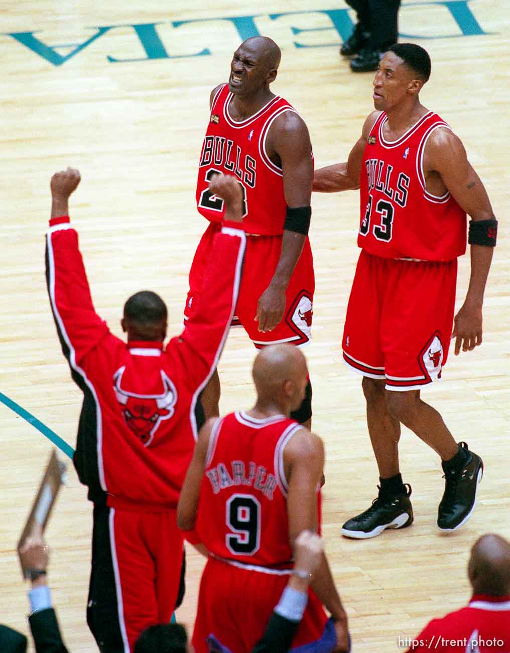 Michael Jordan after hitting the game winning bucket, celebrates with teammates Scottie Pippen and others at Jazz vs. Bulls, game 6 of the NBA Finals. Bulls won