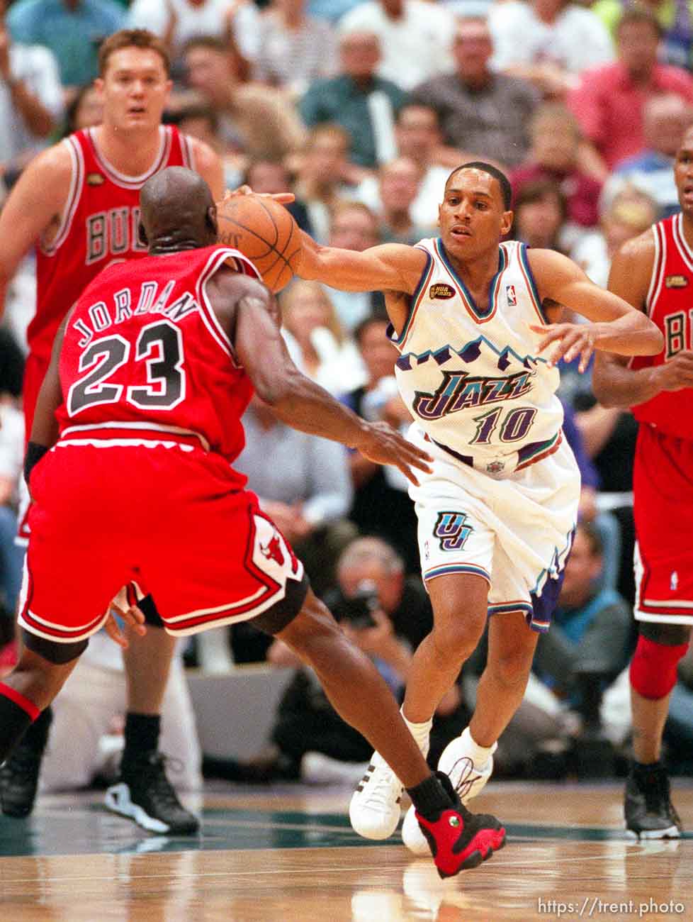 Howard Eisley pushes ball past Michael Jordan