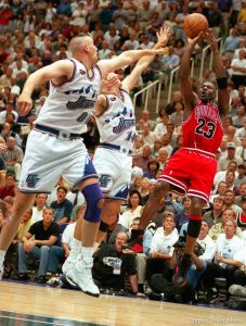 Michael Jordan shoots a fadeaway jumper over Greg Ostertag and Jeff Hornacek at Jazz vs. Bulls, game 1 of the NBA Finals. Jazz won