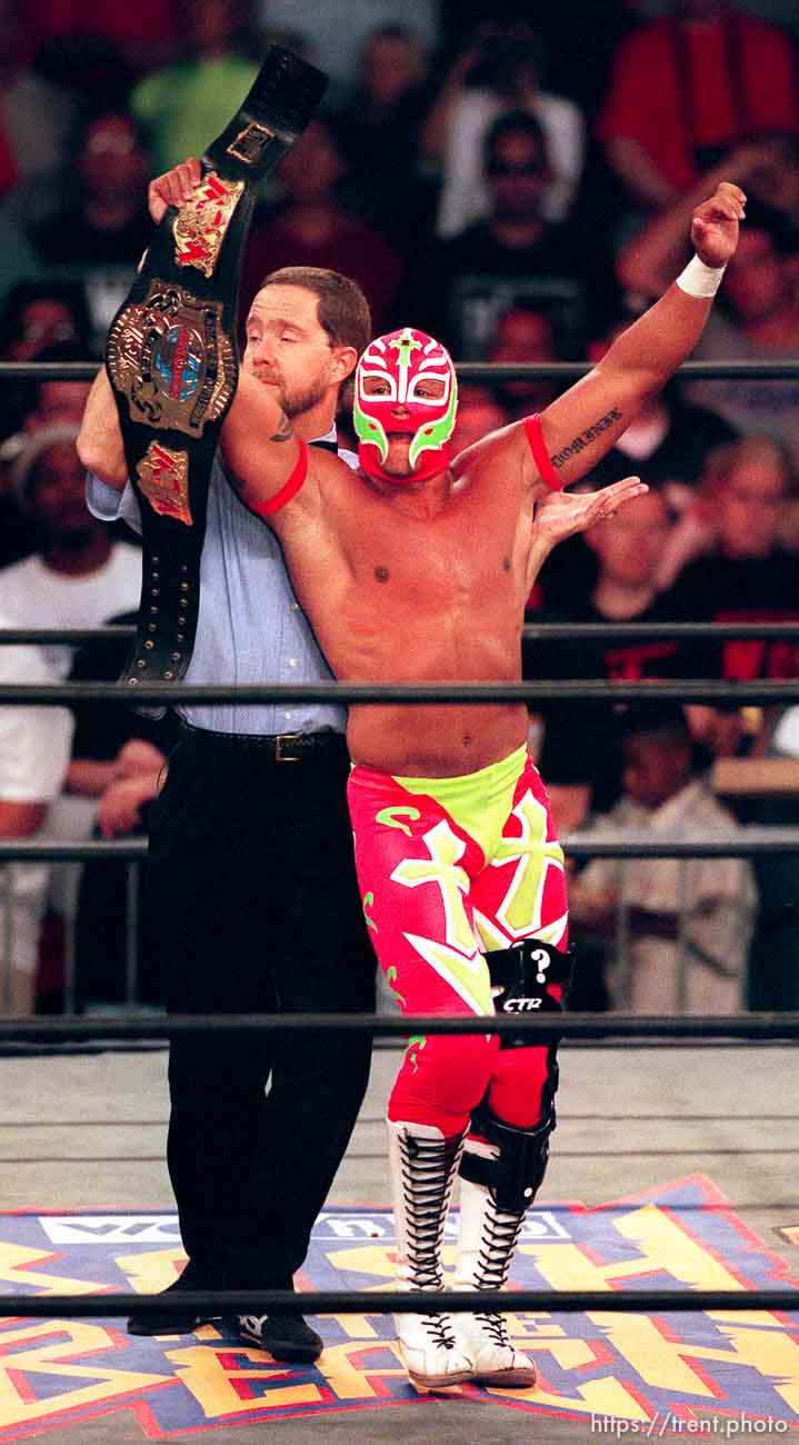 Rey Mysterio Jr. holds a championship belt at WCW's Bash at the Beach.