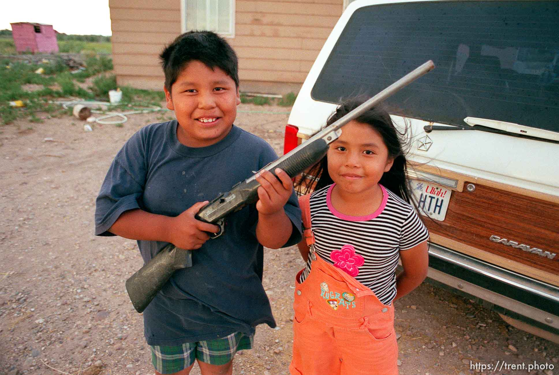 Percy Jenks with a BB gun and his sister Jessy Jenks.