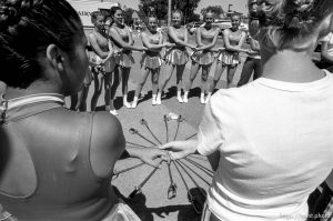 Cyprus High School Spinnakers drill team with sabres at the 4th of July parade on Main Street.