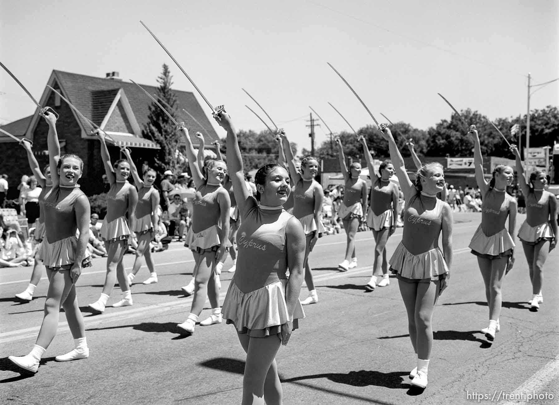 Cyprus High School Spinnakers drill team march with sabres at the 4th of July parade on Main Street.