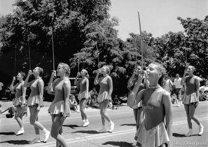 Cyprus High School Spinnakers drill team march with sabres at the 4th of July parade on Main Street.