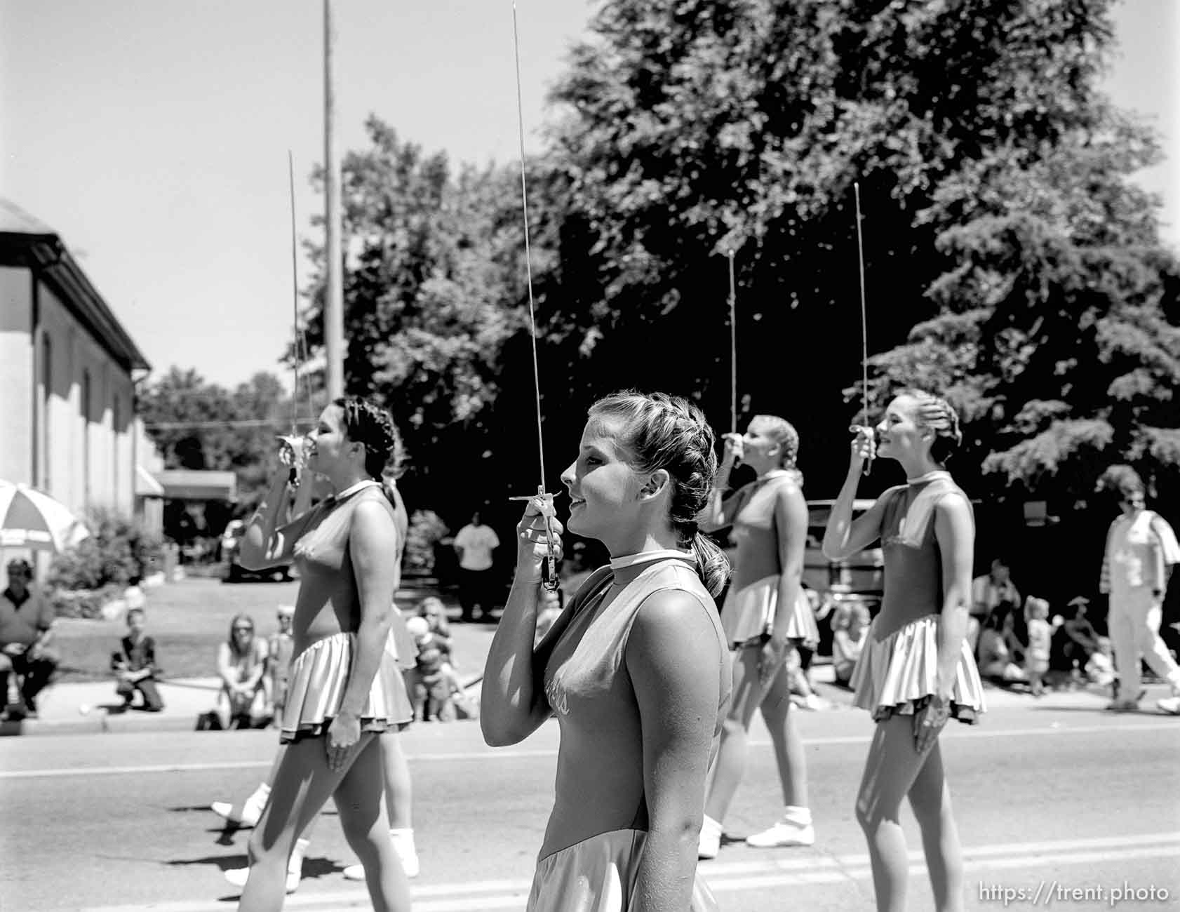 Cyprus High School Spinnakers drill team march with sabres at the 4th of July parade on Main Street.