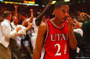 Utah's Andre Miller walks off the court as Utah State celebrates their win over 9th ranked Utah at Utah vs. Utah State.