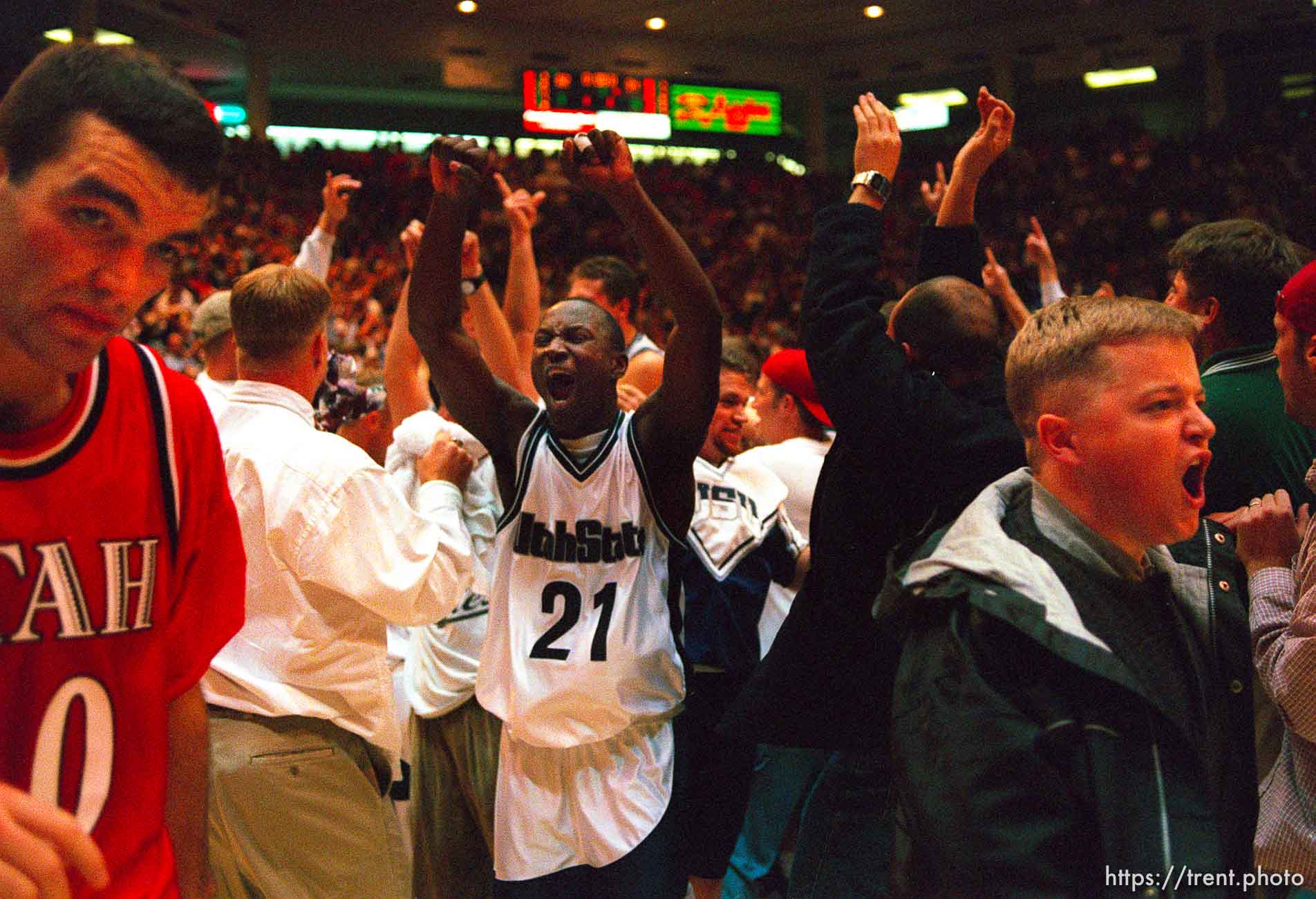 Utah's Alex Jensen walks off the court as Utah State (#21- Tyrone Allick) celebrates their win over 9th ranked Utah at Utah vs. Utah State.