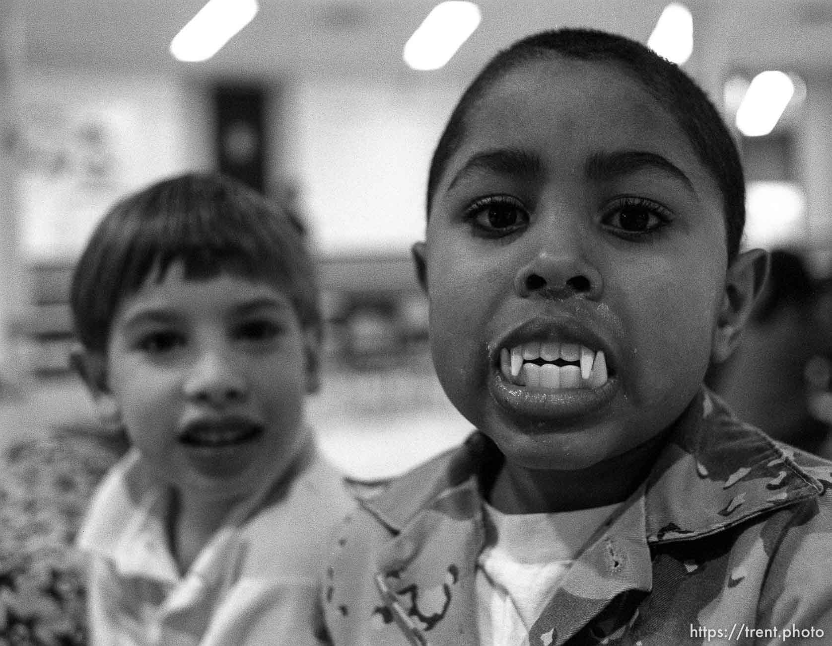 Kid with toy vampire teeth in the after-school care program at Dee Elementary School.