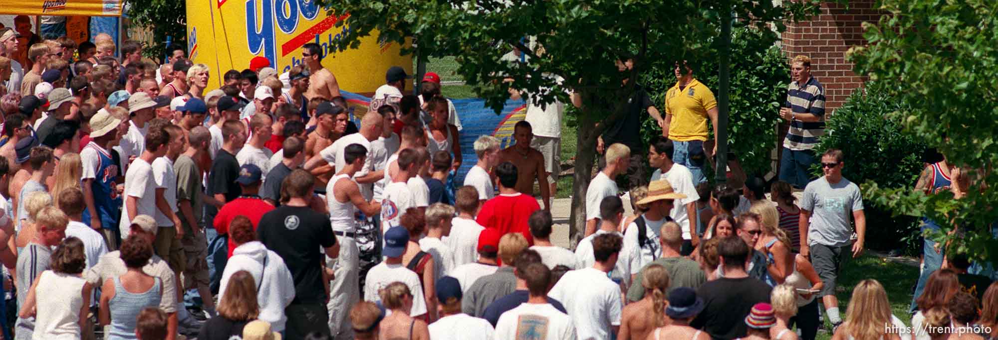 Straightedge chase security and some other guy into a building (guard in yellow jacket is holding a chair) at the Vans Warped Tour.