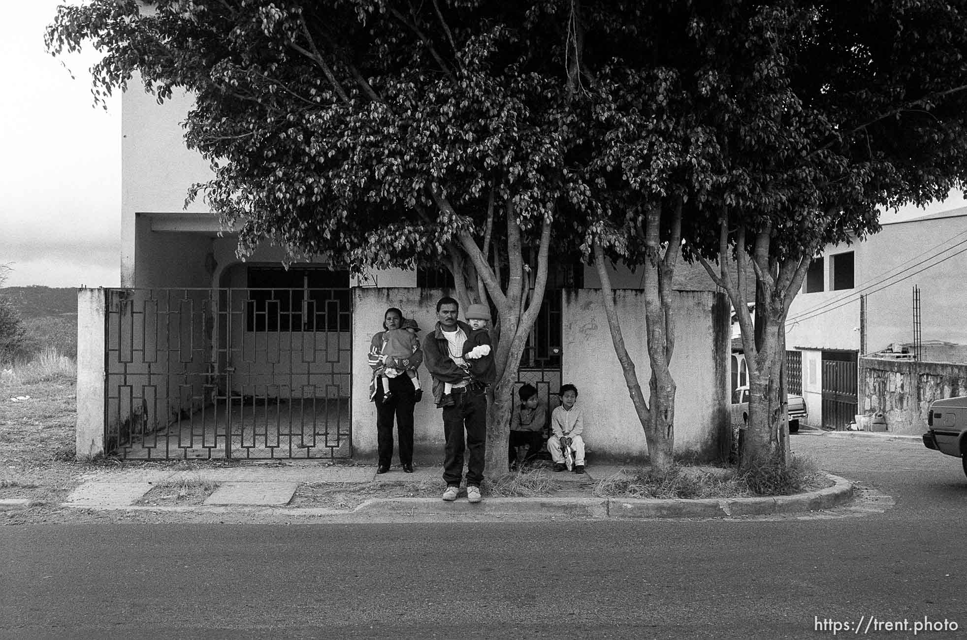 Doris holding Bessy, Jose holding Doris, Eduardo, Hexi, waiting for a taxi. Formerly conjoined twins, Bessy and Doris Gonzales.