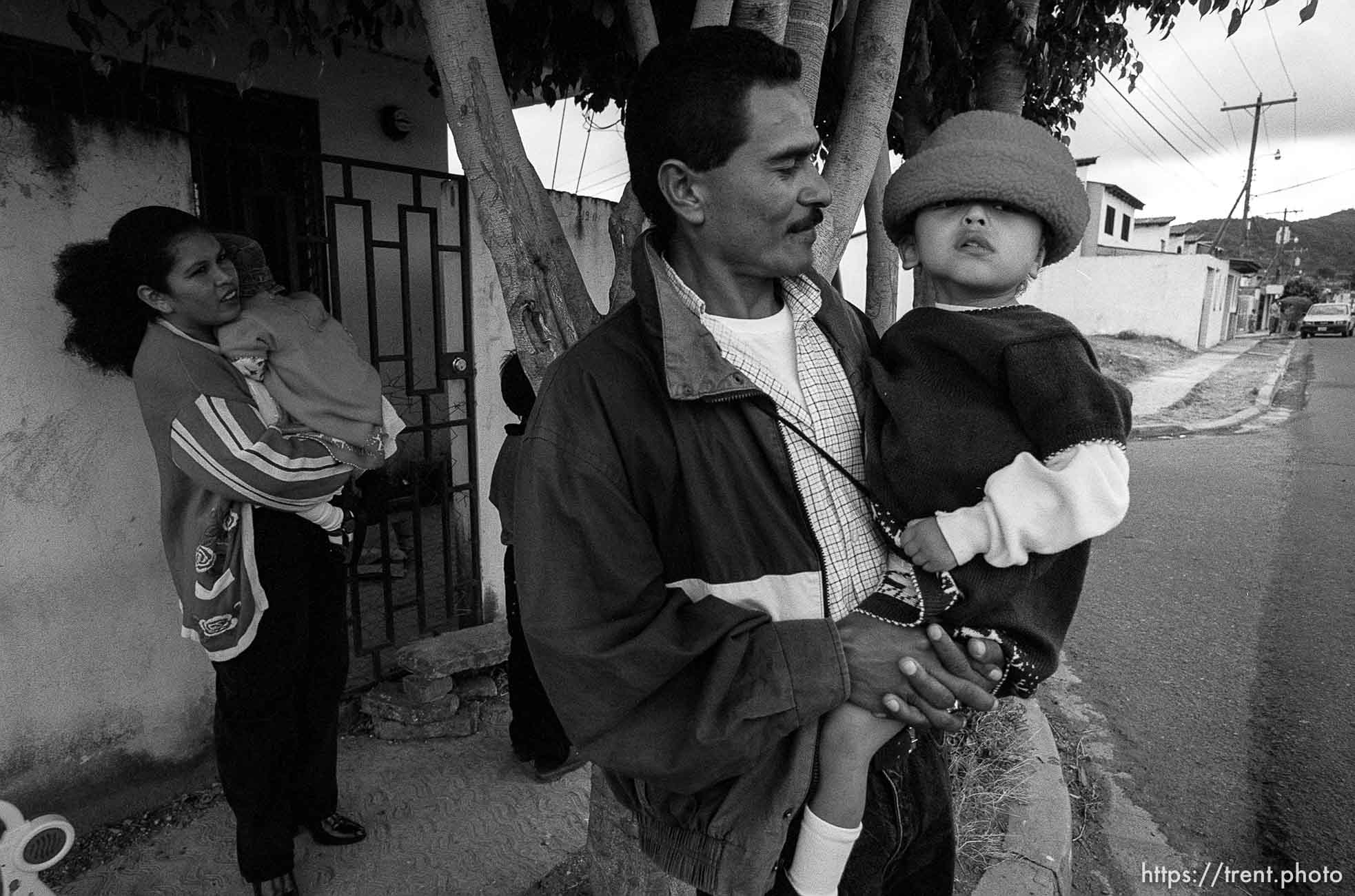 Doris holding Bessy, Jose holding Doris. Formerly conjoined twins, Bessy and Doris Gonzales.