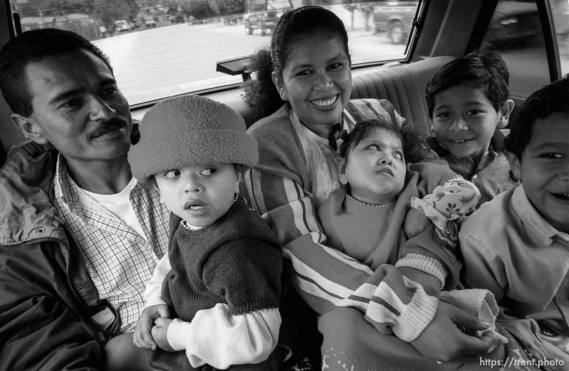 In a taxi, Jose, Doris, Doris, Bessy, Eduardo, Hexi. Formerly conjoined twins, Bessy and Doris Gonzales.