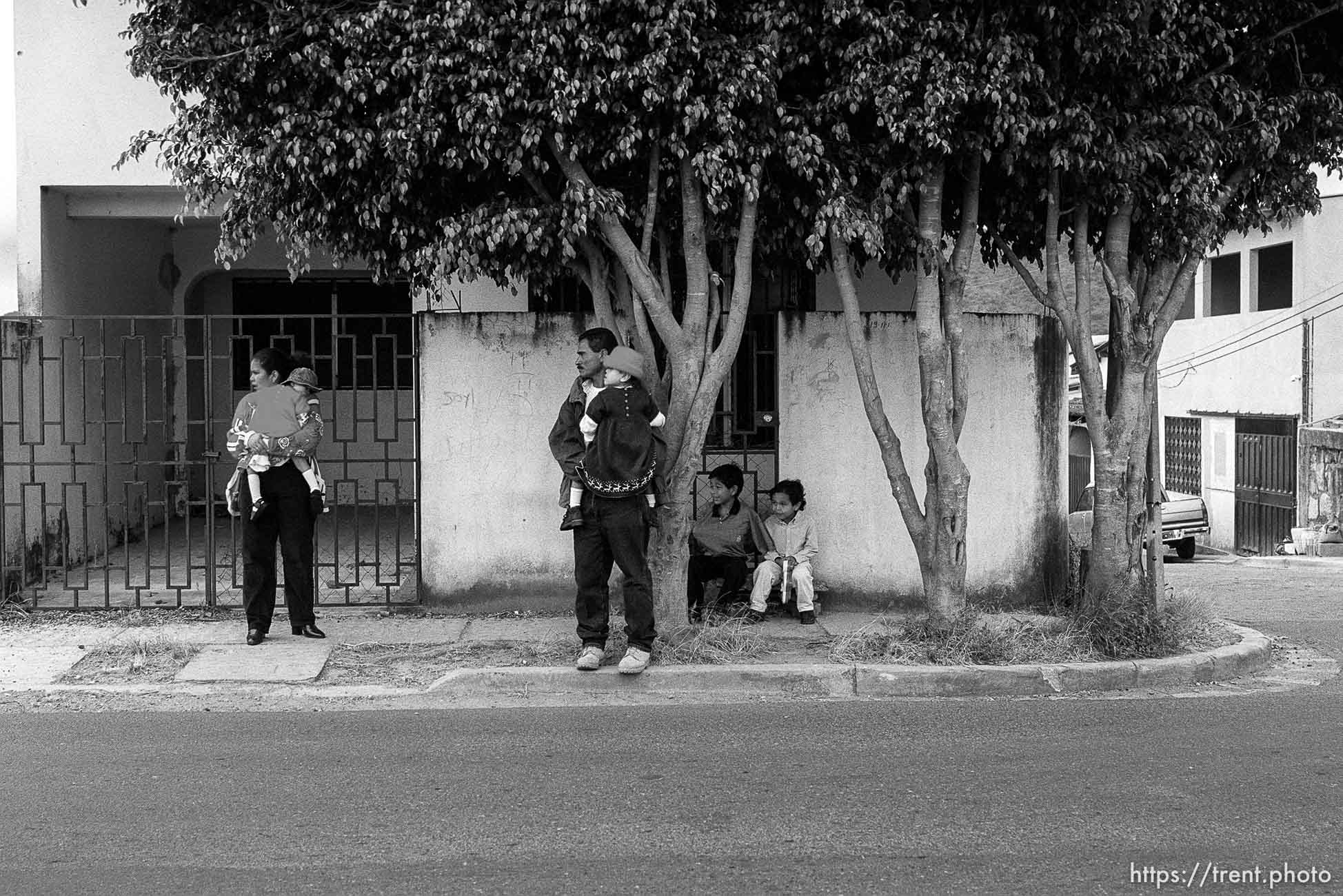 Waiting for a taxi, Doris holding Bessy, Jose holding Doris, Eduardo, Hexi. Formerly conjoined twins, Bessy and Doris Gonzales.